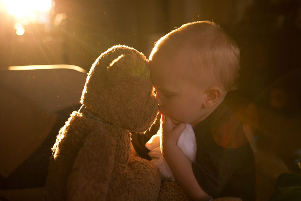 documentary family photography - baby with best friend bear