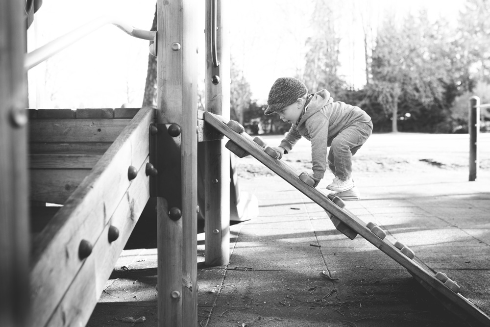 documentary family photography - toddler on a climber at the park