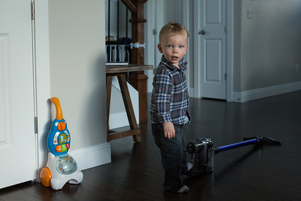 documentary family photography - toddler with a Dyson vacuum
