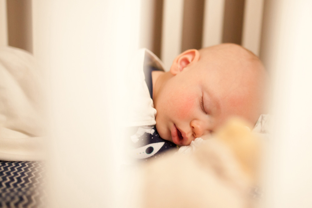 documentary family photography - baby in crib